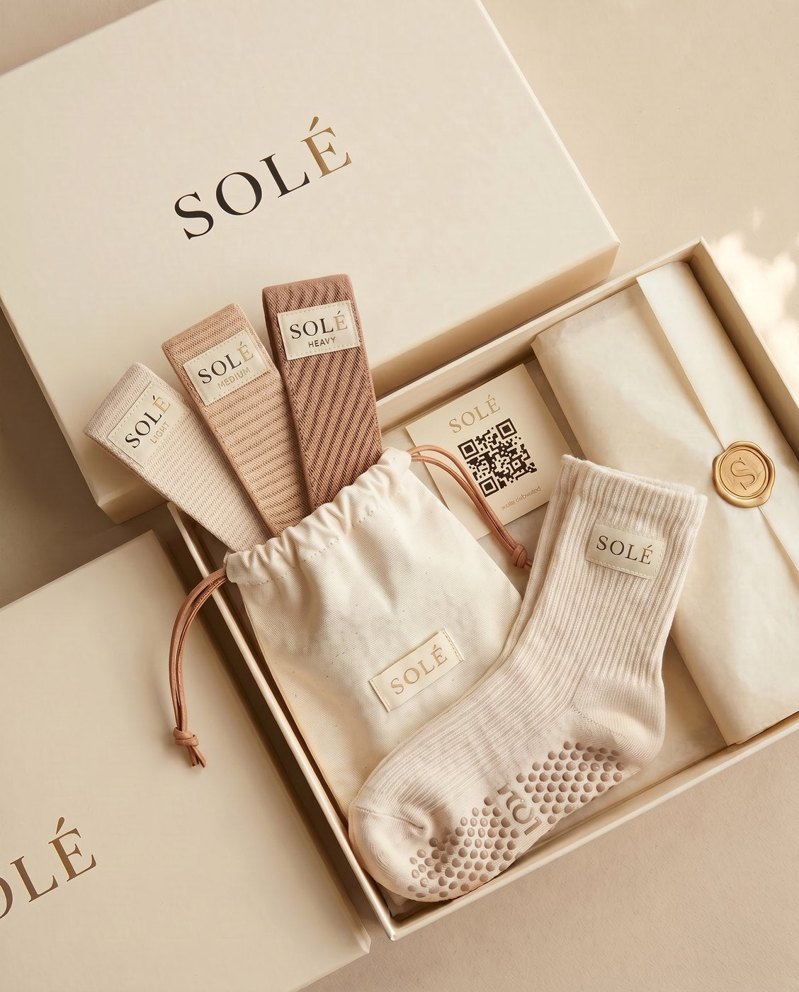 SOLÉ Starter Kit — grip socks, fabric band set and pouch in a cream gift box